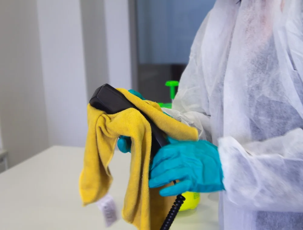 Cleaning cloths, gloves and eco-friendly spray bottles laid out ready for a job.