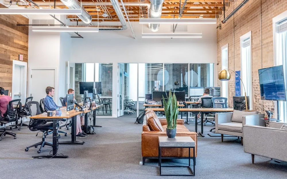 A bright open plan office with clean desks and flooring.